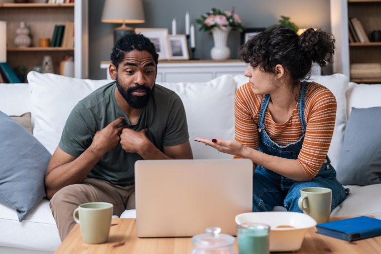 young couple attending online therapy through laptop